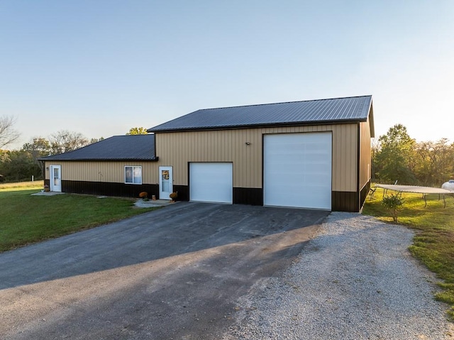 garage featuring a lawn and wooden walls