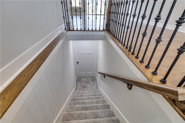 stairs featuring baseboards and wood finished floors