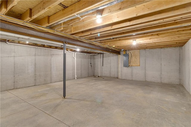 unfinished basement featuring electric panel