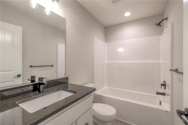 full bathroom featuring bathtub / shower combination, vanity, and toilet