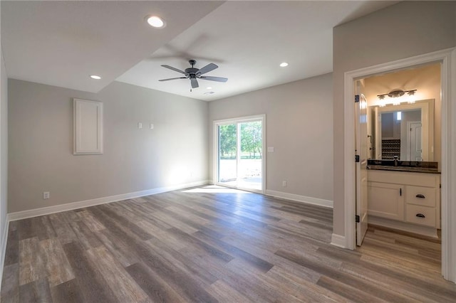 interior space with connected bathroom, ceiling fan, access to outside, and light hardwood / wood-style flooring