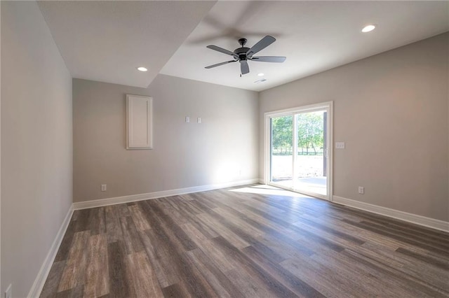 empty room with dark hardwood / wood-style floors and ceiling fan