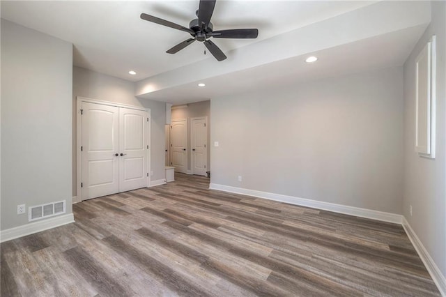 unfurnished bedroom with ceiling fan and wood-type flooring