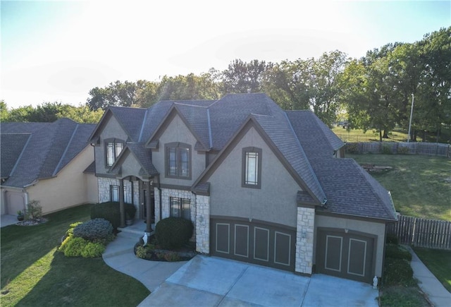 view of front of property featuring a front yard and a garage