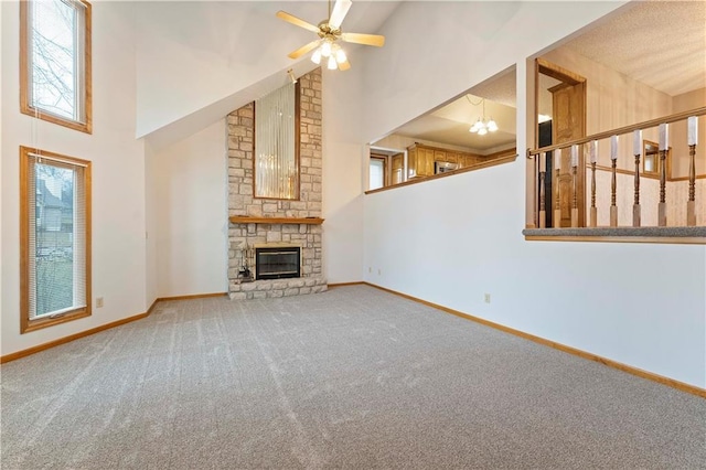 unfurnished living room featuring a high ceiling, a fireplace, and baseboards