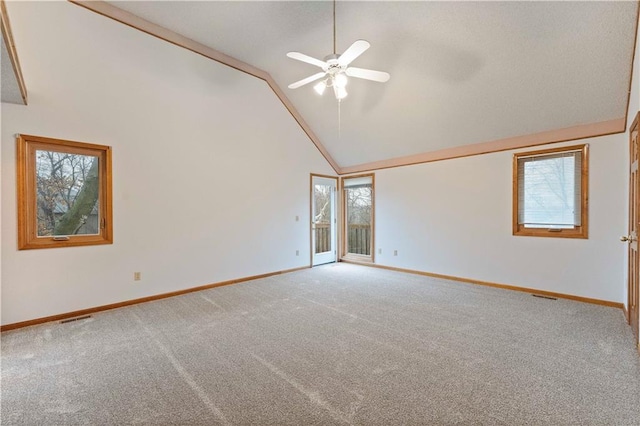 unfurnished room featuring carpet floors, visible vents, high vaulted ceiling, and baseboards