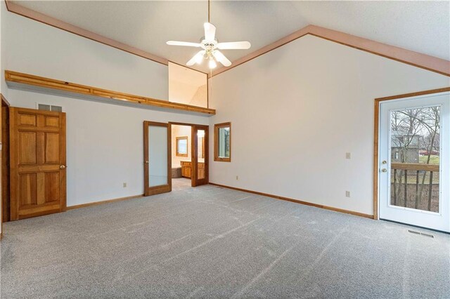 interior space featuring carpet floors, baseboards, visible vents, and high vaulted ceiling