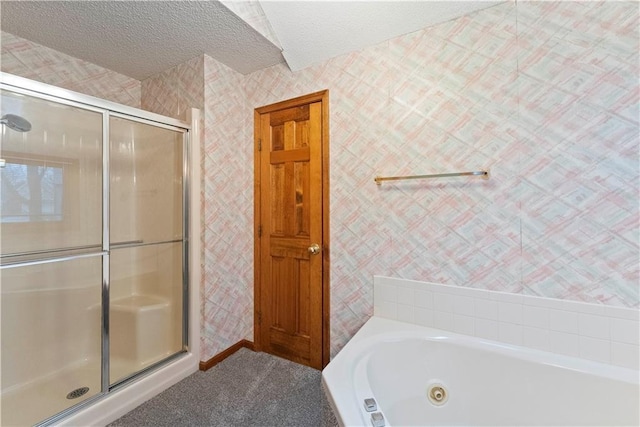 full bath featuring a tub with jets, a shower stall, a textured ceiling, and wallpapered walls