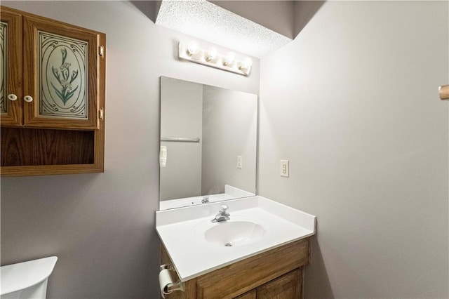 bathroom with toilet and vanity