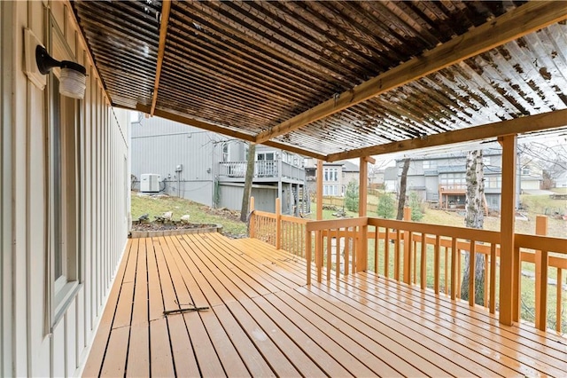 deck featuring cooling unit, a residential view, and a pergola