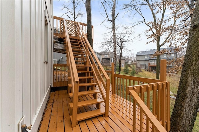 wooden terrace featuring a residential view and stairs