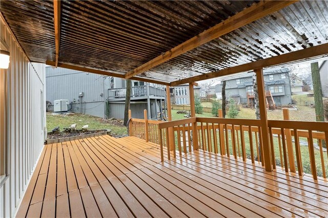 wooden terrace featuring central AC, a residential view, and a pergola