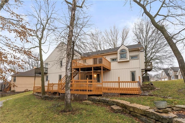 rear view of house with a deck, a lawn, and a chimney