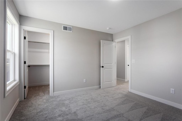 13424 W 178th St, Overland Park, KS 66013 - unfurnished bedroom featuring carpet, multiple windows, a walk in closet, and a closet