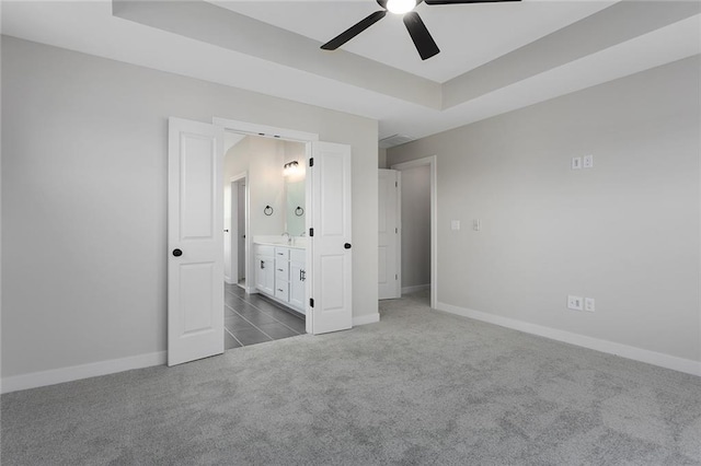 13424 W 178th St, Overland Park, KS 66013 - unfurnished bedroom featuring dark carpet, a raised ceiling, ensuite bath, and a ceiling fan