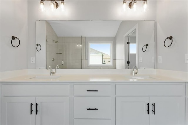 13424 W 178th St, Overland Park, KS 66013 - bathroom featuring double vanity, tiled shower, and lofted ceiling