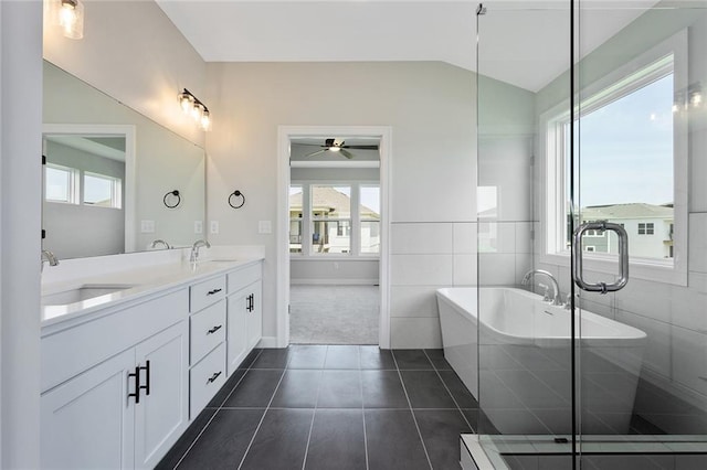 13424 W 178th St, Overland Park, KS 66013 - bathroom featuring a soaking tub, double vanity, ceiling fan, tile patterned floors, and plenty of natural light