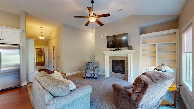 living room featuring built in shelves, lofted ceiling, ceiling fan, and dark wood-type flooring