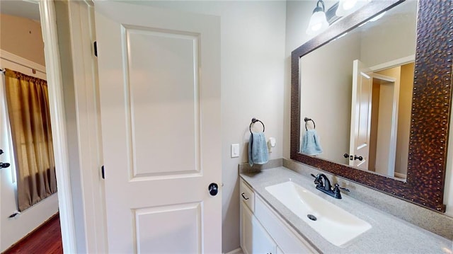 bathroom with hardwood / wood-style floors and vanity