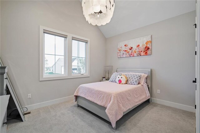 carpeted bedroom with vaulted ceiling