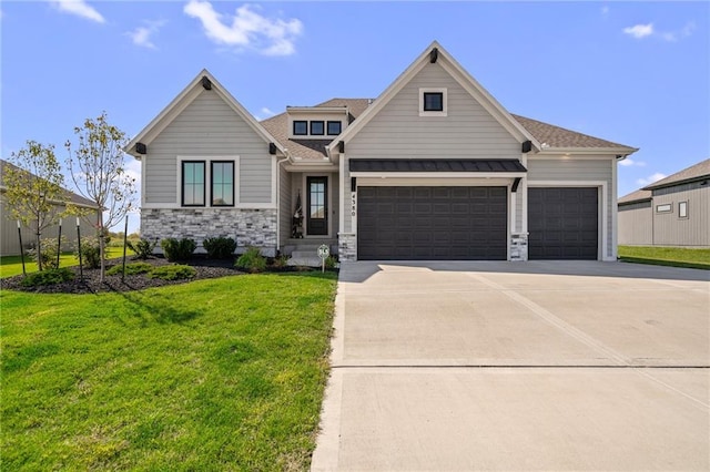 craftsman-style home with a garage and a front lawn