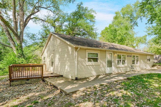 view of front of property with a wooden deck and a patio area