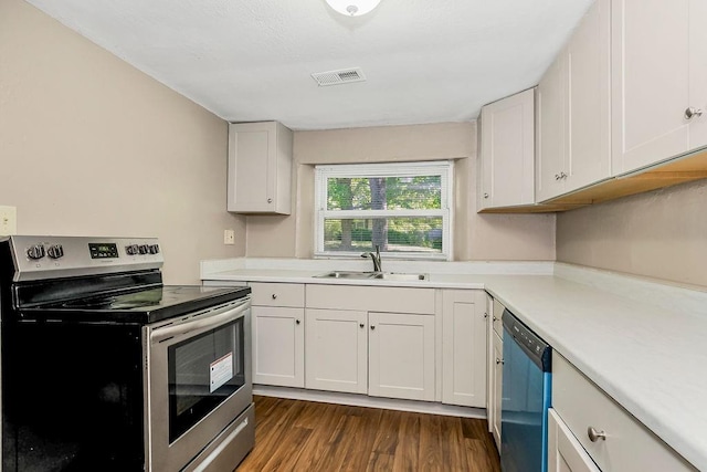 kitchen featuring white cabinetry, appliances with stainless steel finishes, dark wood-type flooring, and sink