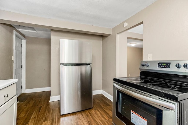 kitchen with stainless steel appliances and dark hardwood / wood-style flooring