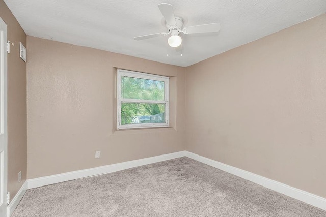 unfurnished room with ceiling fan and light carpet