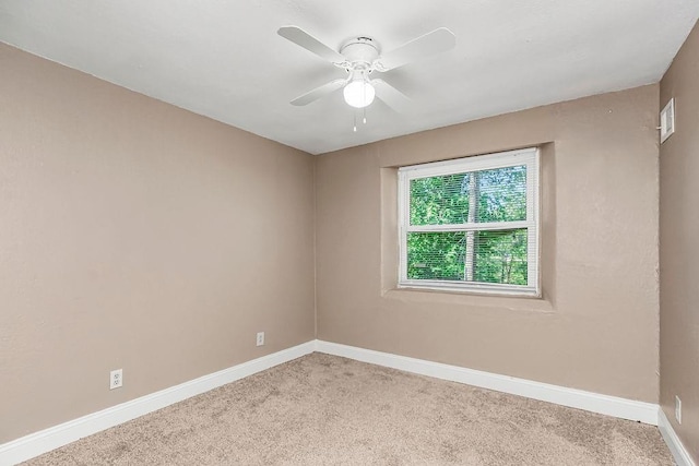 unfurnished room featuring light carpet and ceiling fan