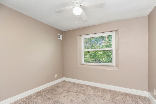 carpeted spare room with ceiling fan