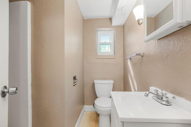 bathroom with vanity, toilet, and tile patterned floors