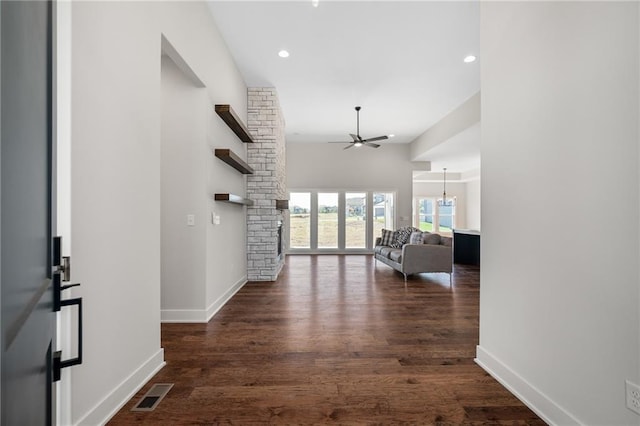 hall with a notable chandelier and dark hardwood / wood-style floors