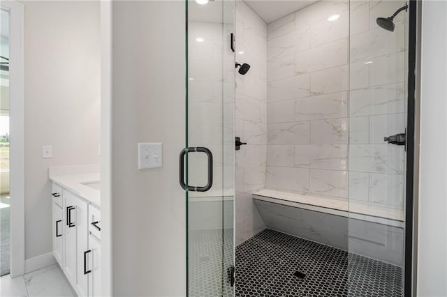 bathroom featuring vanity and a shower with shower door