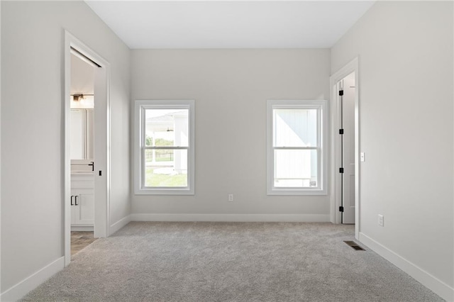 empty room with light colored carpet