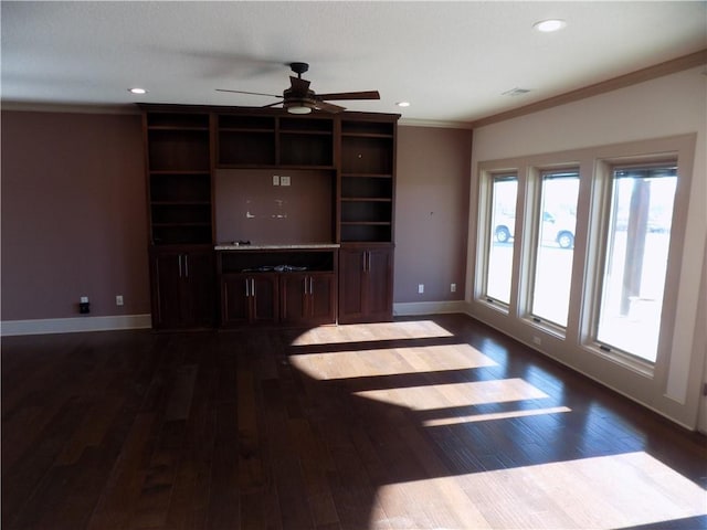 unfurnished living room with crown molding, ceiling fan, and dark hardwood / wood-style floors