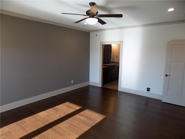 spare room with ceiling fan, dark hardwood / wood-style flooring, and ornamental molding