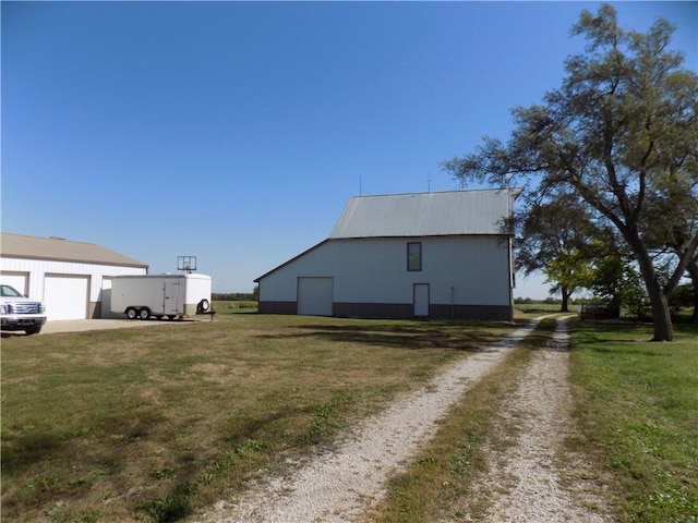 view of side of property featuring a yard and an outbuilding