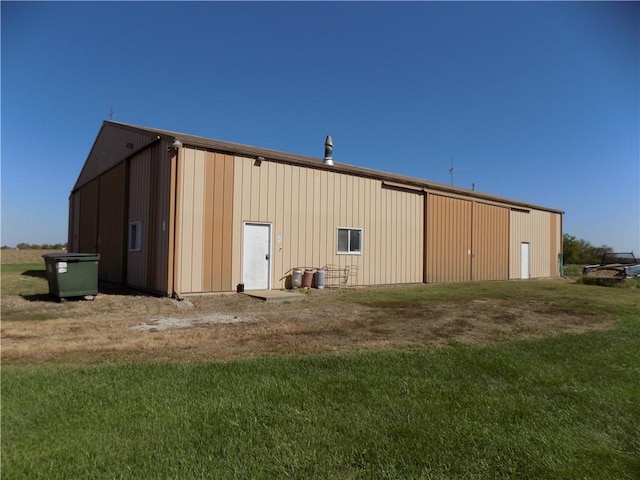 view of outdoor structure featuring a lawn