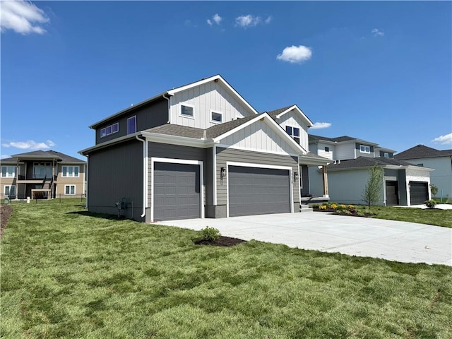 view of front of property featuring a garage, driveway, a front yard, and board and batten siding