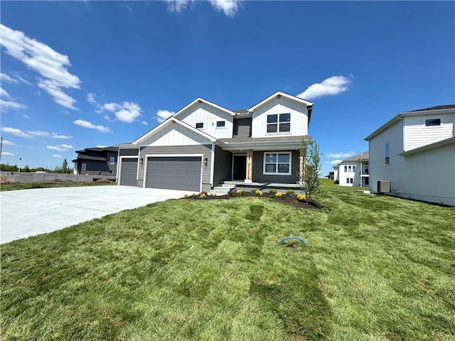 view of front facade featuring covered porch, an attached garage, concrete driveway, a front yard, and board and batten siding