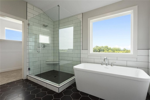 13428 W 178th St, Overland Park, KS 66013 - full bathroom with a shower stall, tile patterned floors, a freestanding bath, tile walls, and lofted ceiling