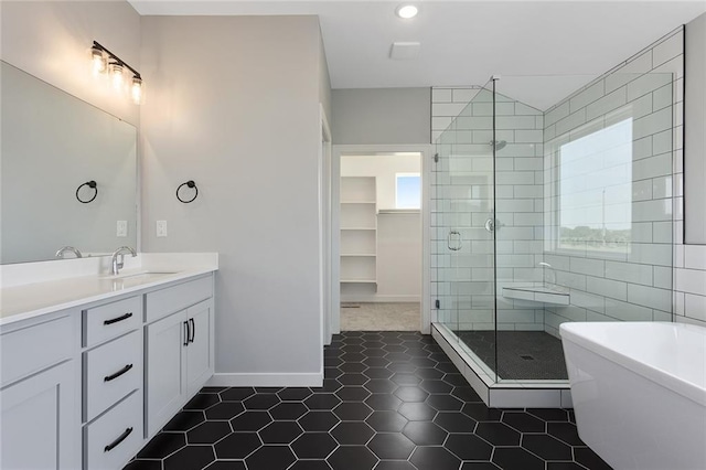 13428 W 178th St, Overland Park, KS 66013 - full bath with a stall shower, vanity, a freestanding bath, tile patterned floors, and a walk in closet
