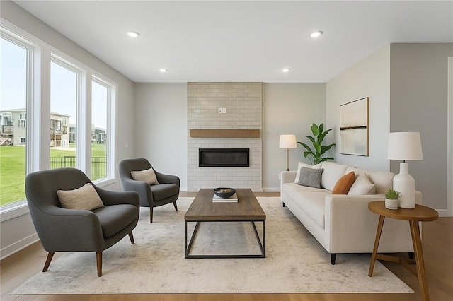 13428 W 178th St, Overland Park, KS 66013 - living area featuring plenty of natural light, light wood finished floors, a fireplace, and recessed lighting