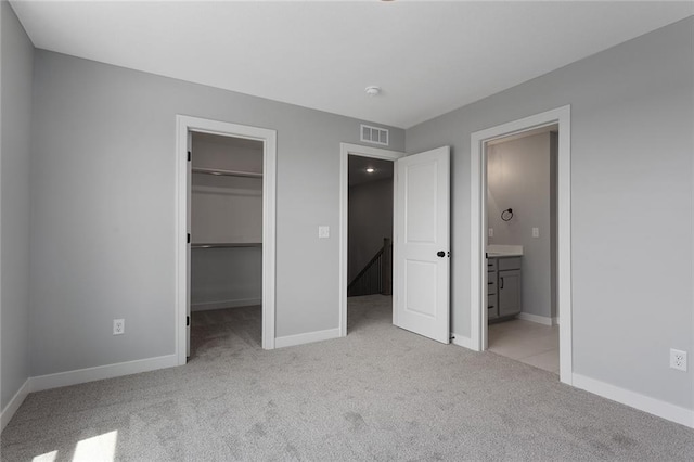 13428 W 178th St, Overland Park, KS 66013 - unfurnished bedroom featuring light carpet, a walk in closet, ensuite bathroom, and a closet