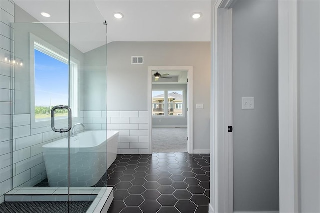 13428 W 178th St, Overland Park, KS 66013 - bathroom featuring a freestanding bath, healthy amount of natural light, tile patterned flooring, ceiling fan, and tile walls