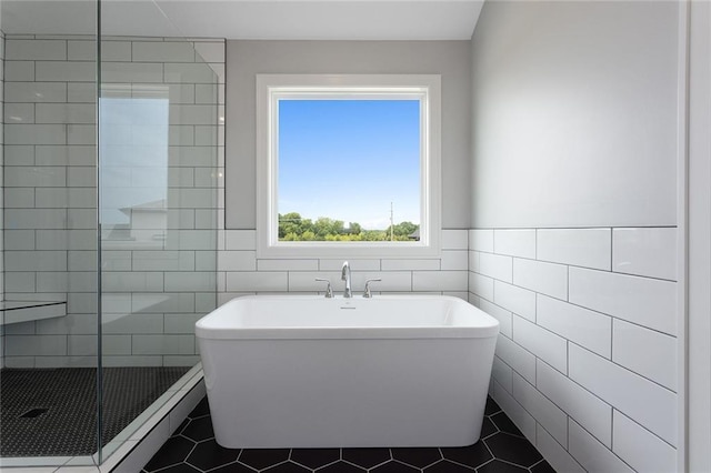 13428 W 178th St, Overland Park, KS 66013 - full bathroom featuring a soaking tub, tile walls, tile patterned floors, and a tile shower
