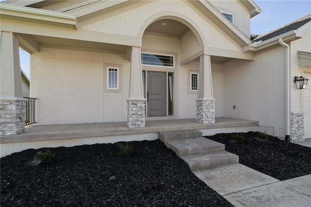 view of exterior entry featuring a porch