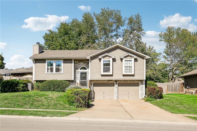 split foyer home featuring a front yard and a garage