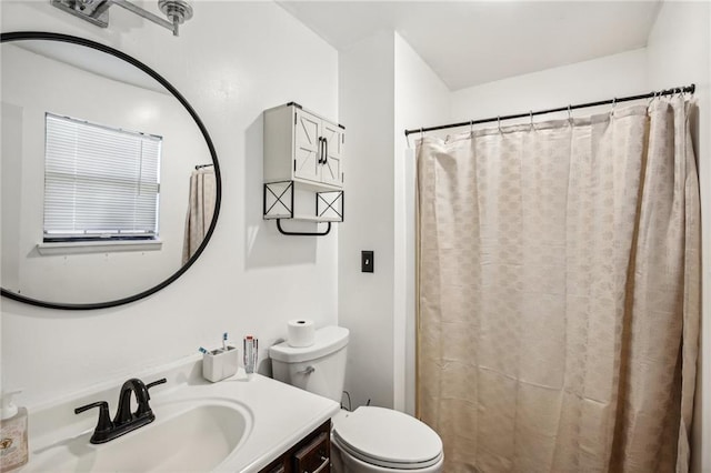 bathroom with walk in shower, vanity, and toilet